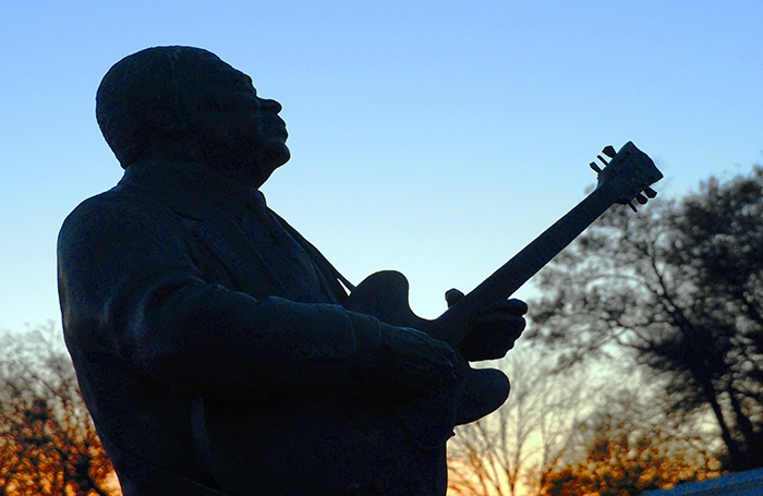 Statue von B.B. King mit Gitarre im Stadtpark von Indianola vor Sonnenuntergang.