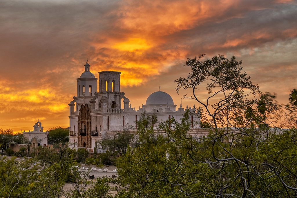 Mission San Xavier del Bac at sunset with colorful sky near Tucson, Arizona.