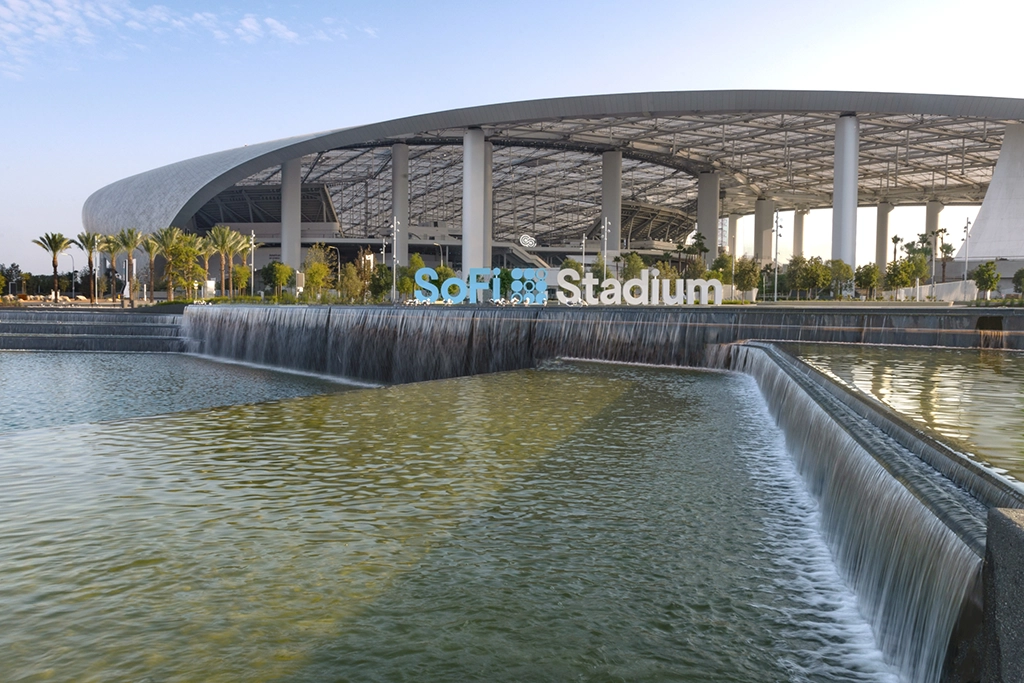 SoFi Stadium in Inglewood mit Wasserbecken, Fußweg und moderner Dachkonstruktion