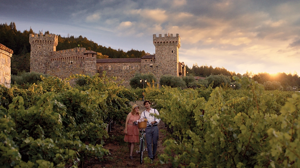 Paar im Weinberg vor dem Castello di Amorosa im Napa Valley bei Sonnenuntergang