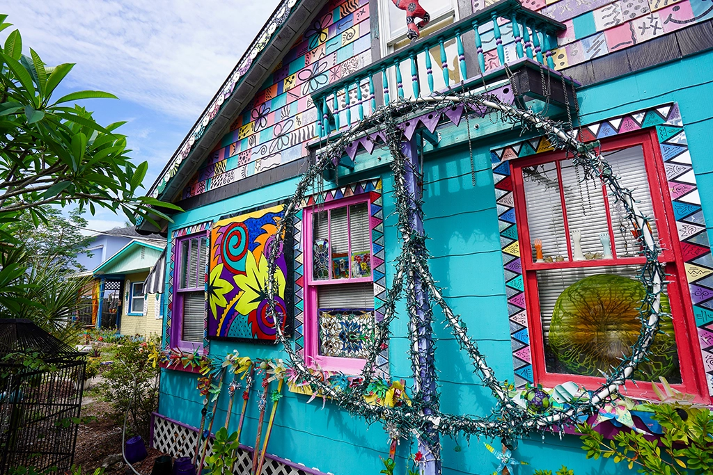 Farbenfroh bemaltes Wohnhaus mit Peace-Zeichen und Kunstinstallationen in Whimzeyland, Safety Harbor.
