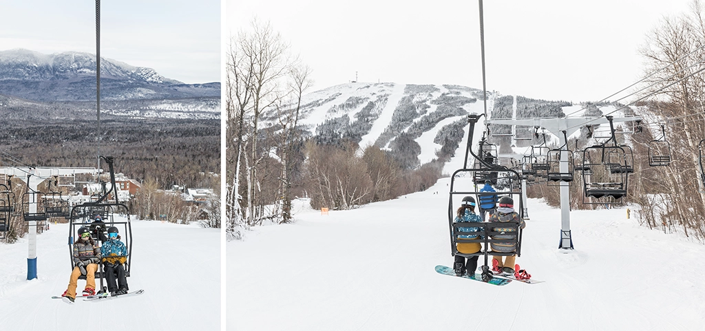 Skifahrer und Snowboarder im Sessellift des Skigebiets Sugarloaf in Maine mit Blick auf verschneite Pisten und Berge